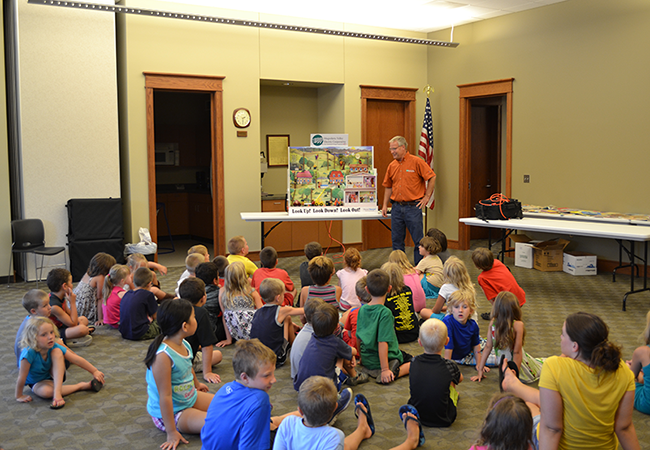 Al Schilling, Member Advocate, uses the Hazard Hamlet display to teach children how to be safe around electricity.
